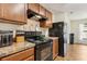 Spacious kitchen featuring wood cabinets and granite countertops at 3845 Arborvitae Way, Deland, FL 32724