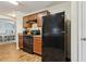 This kitchen features wood cabinets, a black appliance package and stylish laminate countertops at 3845 Arborvitae Way, Deland, FL 32724