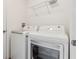 Laundry area with a modern washer and dryer, and a wire shelf at 3845 Arborvitae Way, Deland, FL 32724