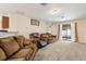 Spacious living room with plush carpet, comfortable couches, and sliding glass doors leading to the pool at 3845 Arborvitae Way, Deland, FL 32724