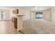 Open concept living room with breakfast bar, leading into open living space at 3845 Arborvitae Way, Deland, FL 32724