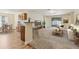 Open concept living room with breakfast bar, leading into open living space at 3845 Arborvitae Way, Deland, FL 32724