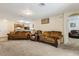 Inviting living room with plush carpet, comfortable couches, and an open layout into the kitchen at 3845 Arborvitae Way, Deland, FL 32724
