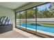Screened lanai overlooking a beautiful pool with a small fountain and a well-maintained yard at 3845 Arborvitae Way, Deland, FL 32724