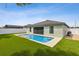 Backyard view of the pool, patio, and home exterior showing the well maintained lawn at 3845 Arborvitae Way, Deland, FL 32724
