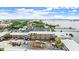 Aerial view of property complex showing parking, surrounding trees, and waterfront location at 411 N Halifax Ave # 304, Daytona Beach, FL 32118