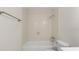 Bathroom with a tub, toilet, vanity, and neutral tiles at 411 N Halifax Ave # 304, Daytona Beach, FL 32118