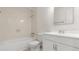 Bathroom with a tub, toilet, vanity, and neutral tiles at 411 N Halifax Ave # 304, Daytona Beach, FL 32118