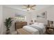Staged bedroom showcasing neutral decor and a bright window at 411 N Halifax Ave # 304, Daytona Beach, FL 32118