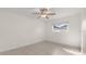 Bright bedroom featuring a ceiling fan and neutral tile flooring at 411 N Halifax Ave # 304, Daytona Beach, FL 32118