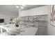 Bright dining area features a white table set for six, an open kitchen with bar top, and modern decor at 411 N Halifax Ave # 304, Daytona Beach, FL 32118