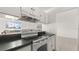 Compact kitchen features white appliances, white cabinets, a breakfast bar, and lots of counter space at 411 N Halifax Ave # 304, Daytona Beach, FL 32118