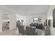 Staged living room with tile floors, neutral walls, and bright natural light. The kitchen is conveniently nearby at 411 N Halifax Ave # 304, Daytona Beach, FL 32118