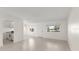 Clean, neutral living room area with bright windows and views to the outside. Tile floor throughout at 411 N Halifax Ave # 304, Daytona Beach, FL 32118