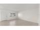 An empty living room space with neutral walls and tile flooring with lots of bright natural light at 411 N Halifax Ave # 304, Daytona Beach, FL 32118