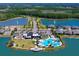 Aerial view of the community's clubhouse, pool area, and playground nestled between two serene lakes and lush landscaping at 418 Aquamarine Way, Daytona Beach, FL 32124