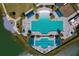 Aerial view showcasing the community pool with lounge chairs, umbrellas, and palm trees lining the pool deck at 418 Aquamarine Way, Daytona Beach, FL 32124
