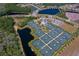 Overhead view of the Florida Tennis Center with many courts, parking and scenic lakes enhancing the community at 418 Aquamarine Way, Daytona Beach, FL 32124