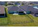 Aerial view of a fenced backyard with a well-kept lawn and a screened patio, ideal for outdoor enjoyment and privacy at 418 Aquamarine Way, Daytona Beach, FL 32124