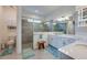 Bright bathroom featuring a walk-in shower, white cabinets, and stone countertops at 418 Aquamarine Way, Daytona Beach, FL 32124
