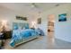 Light and airy bedroom featuring coastal decor and en suite bathroom entrance at 418 Aquamarine Way, Daytona Beach, FL 32124