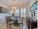 Elegant dining room with a glass table, stylish chandelier, and decorative accents at 418 Aquamarine Way, Daytona Beach, FL 32124