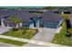 Attractive single-Gathering home featuring a paved driveway, well-kept lawn, and appealing landscaping, enhancing its overall charm at 418 Aquamarine Way, Daytona Beach, FL 32124