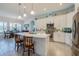 Gourmet kitchen featuring white cabinetry, a spacious island, and modern stainless steel appliances at 418 Aquamarine Way, Daytona Beach, FL 32124