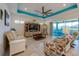 Open living room with a custom ceiling and expansive windows, filling the space with natural light at 418 Aquamarine Way, Daytona Beach, FL 32124
