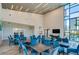 Bright community lounge featuring tables, chairs, and soaring windows, perfect for socializing at 418 Aquamarine Way, Daytona Beach, FL 32124