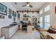 Well-lit home office with built-in shelving, custom desk, and cozy seating area at 418 Aquamarine Way, Daytona Beach, FL 32124