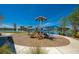 Community playground with slides and swings, set against a scenic lake backdrop, offering fun for all ages at 418 Aquamarine Way, Daytona Beach, FL 32124
