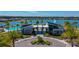 A picturesque aerial view of the resident's club featuring a modern design, pool, and lush landscaping overlooking a tranquil lake at 418 Aquamarine Way, Daytona Beach, FL 32124