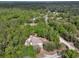 Overhead view of a home nestled among dense trees, showcasing its private and serene location at 4600 S Tomoka Dr, De Leon Springs, FL 32130
