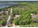 Aerial shot of a home encircled by lush greenery, displaying its spacious lot and secluded environment at 4600 S Tomoka Dr, De Leon Springs, FL 32130