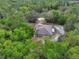 An aerial view of a well-maintained property surrounded by lush trees, providing a secluded and private setting at 4600 S Tomoka Dr, De Leon Springs, FL 32130