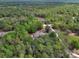 Aerial view of a secluded home surrounded by lush greenery, showcasing its spacious lot and serene location at 4600 S Tomoka Dr, De Leon Springs, FL 32130