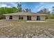 The house has a large backyard with mature landscaping at 4600 S Tomoka Dr, De Leon Springs, FL 32130