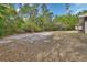 Large backyard space surrounded by mature trees at 4600 S Tomoka Dr, De Leon Springs, FL 32130