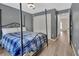Bedroom boasts gray walls, wood floors, and natural light from windows at 4600 S Tomoka Dr, De Leon Springs, FL 32130