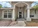 Front entrance shows a well-maintained exterior, and landscaped yard at 4600 S Tomoka Dr, De Leon Springs, FL 32130