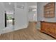 Open hallway with hardwood floors and views of the living area and backyard at 4600 S Tomoka Dr, De Leon Springs, FL 32130