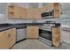Well-equipped kitchen with modern appliances, light wood cabinetry, and ample counter space at 4600 S Tomoka Dr, De Leon Springs, FL 32130