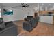 Inviting living room with wood floors and views of the kitchen at 4600 S Tomoka Dr, De Leon Springs, FL 32130