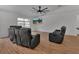 Bright living room featuring wood floors, a ceiling fan, and a mounted TV at 4600 S Tomoka Dr, De Leon Springs, FL 32130
