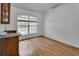 Bright living room with hardwood floors and large arched window at 4600 S Tomoka Dr, De Leon Springs, FL 32130