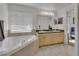 Bright main bathroom with double sinks, garden tub, and glass shower at 4600 S Tomoka Dr, De Leon Springs, FL 32130