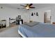 Main bedroom with neutral carpet, ceiling fan, and ensuite bathroom at 4600 S Tomoka Dr, De Leon Springs, FL 32130