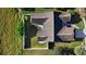 A stunning aerial view of the property showcasing the roof, lush lawn, fenced yard, and landscaped areas at 484 Sherwood Oaks Rd, Orange City, FL 32763