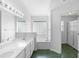 Bright bathroom with double sink vanity, modern fixtures, and a soaking tub with a glass block window at 484 Sherwood Oaks Rd, Orange City, FL 32763